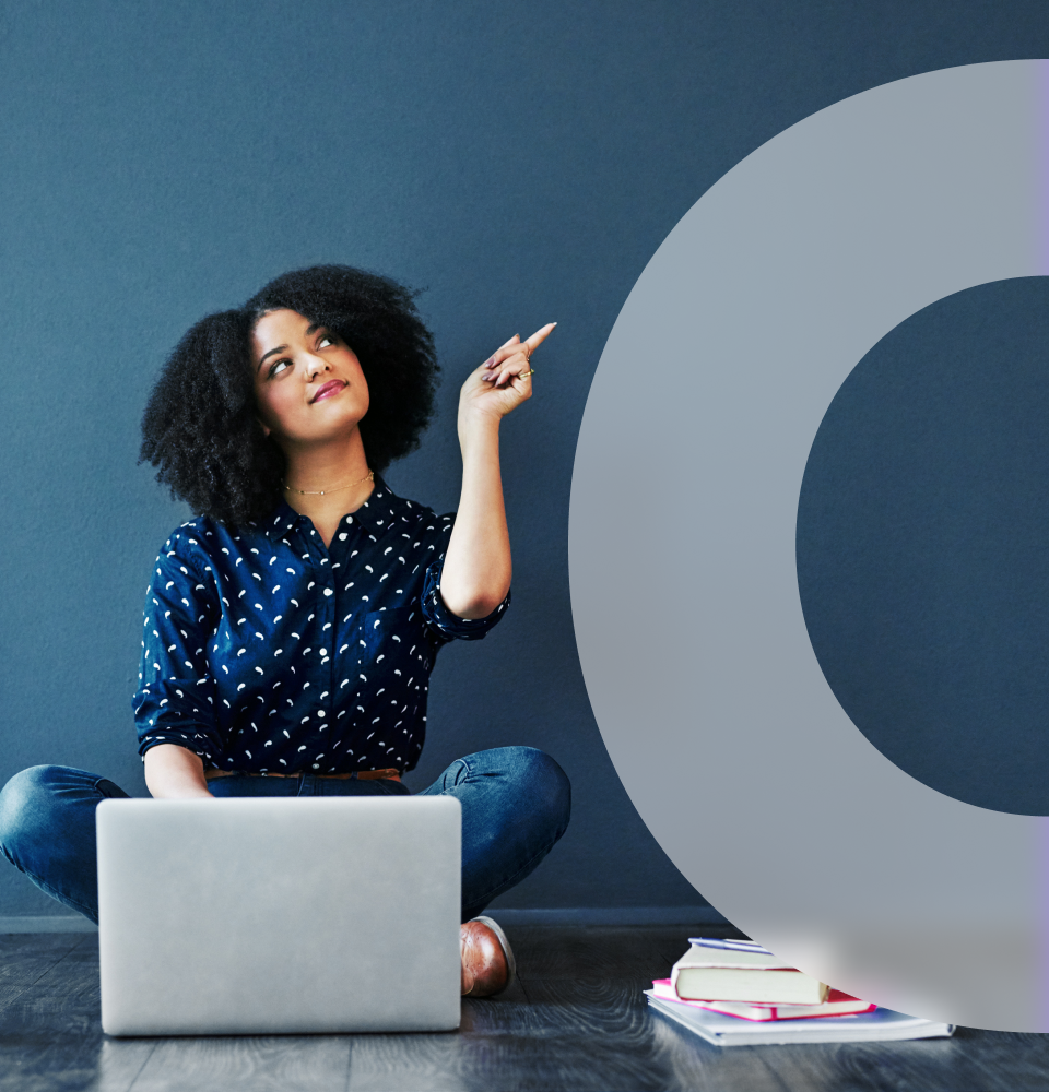 girl with laptop pointing to her left